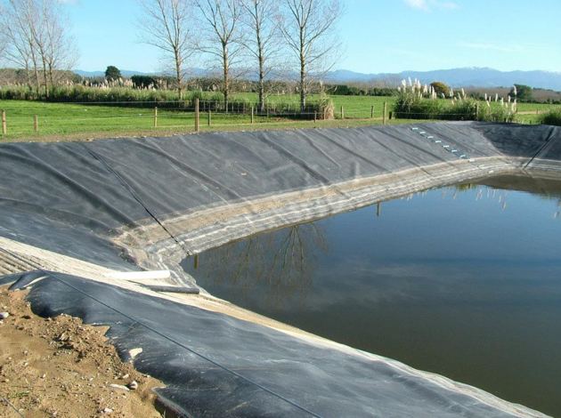 Lined water storage pond on farmland