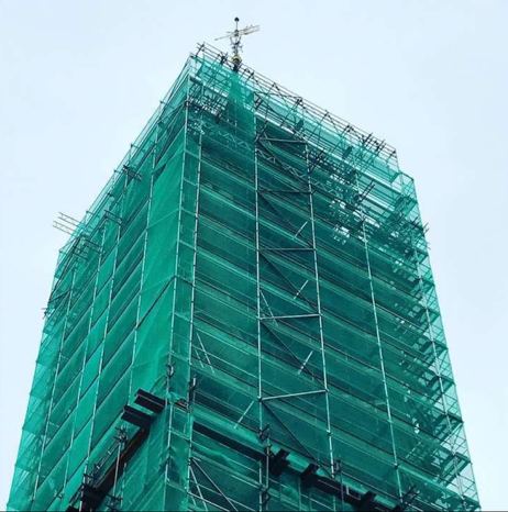 Scaffold netting wrapping a high-rise building