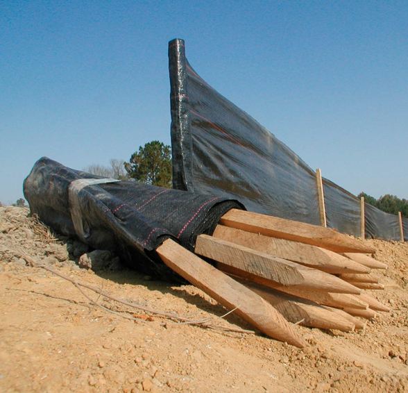 Silt fence installed with timber stakes on a construction site