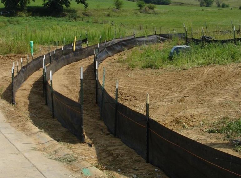 Silt fence running along a graded slope